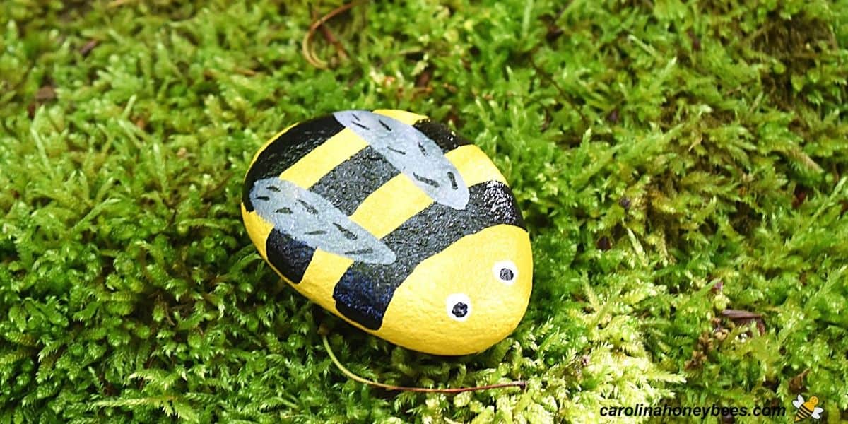 Small round rocks painted to look like a bee.