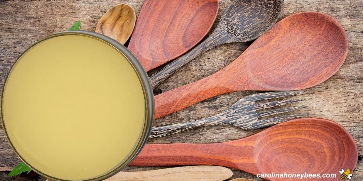 Tin of beeswax wood butter and wooden spoons image.