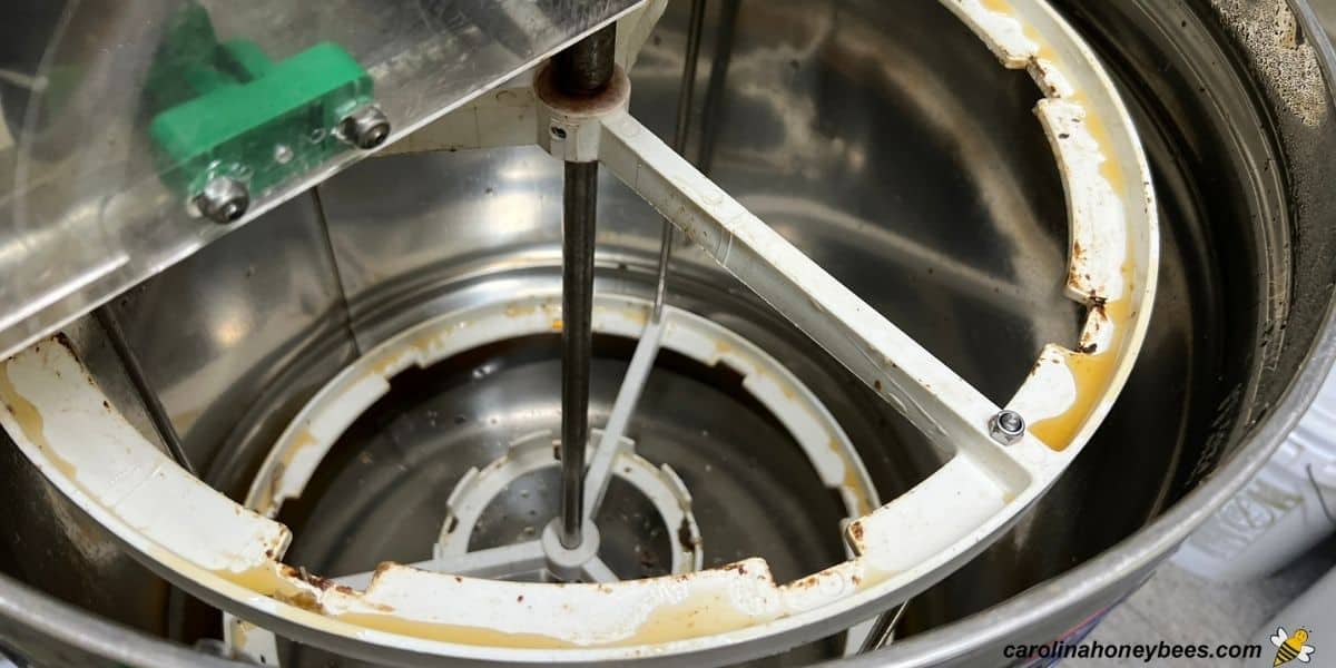 Honey extractor with bits of wax and honey residue inside ready to clean.