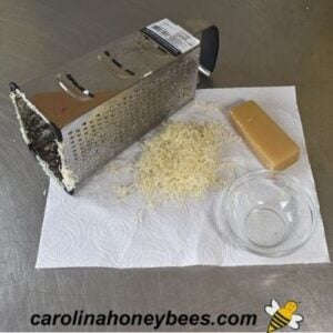 Grated beeswax measured for making beeswax vapor rub recipe image.