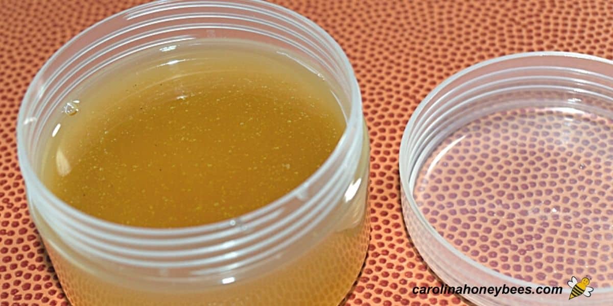 Homemade honey burn salve in a clear container.