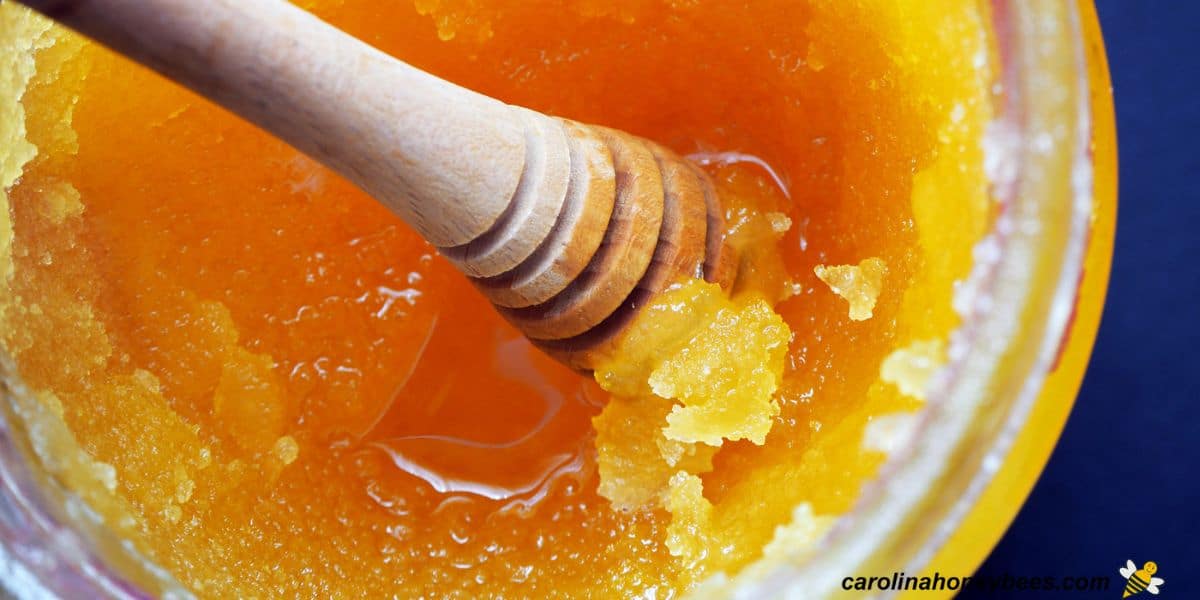 Glass jar with honey that is crystallizing.