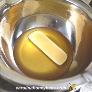 Melting beeswax in a double boiler insert image.