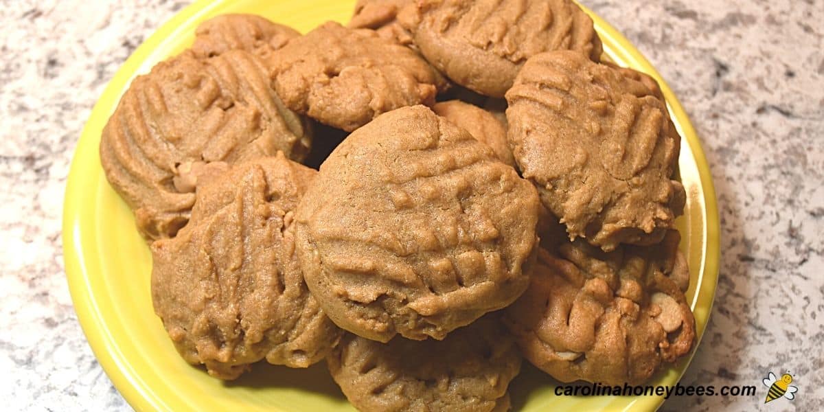 Large yellow plate full of peanut butter honey cookies image.