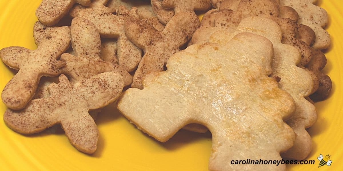 Bee theme shaped honey cookies on a yellow plate.